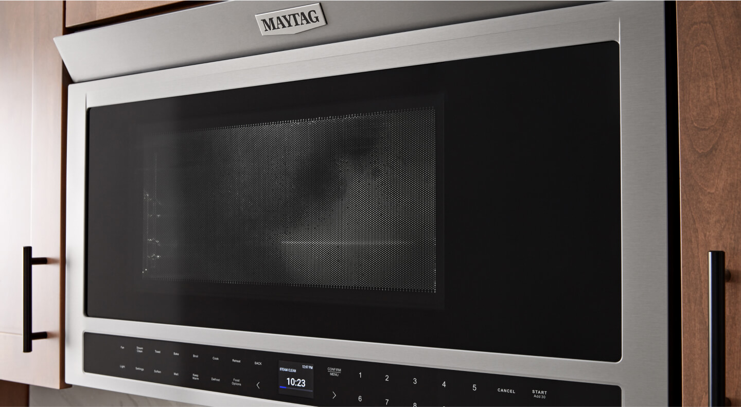 A Maytag® toaster oven installed in brown cabinetry
