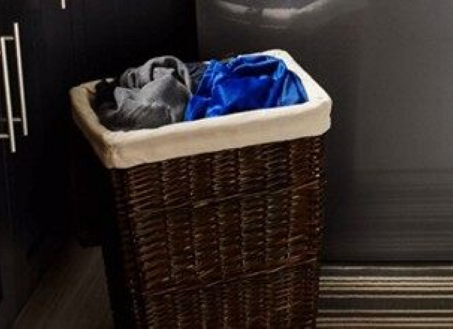 Laundry basket filled with clothes. 