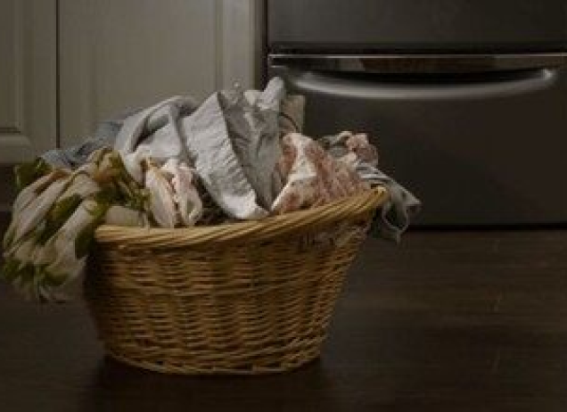 Laundry basket filled with clothes.