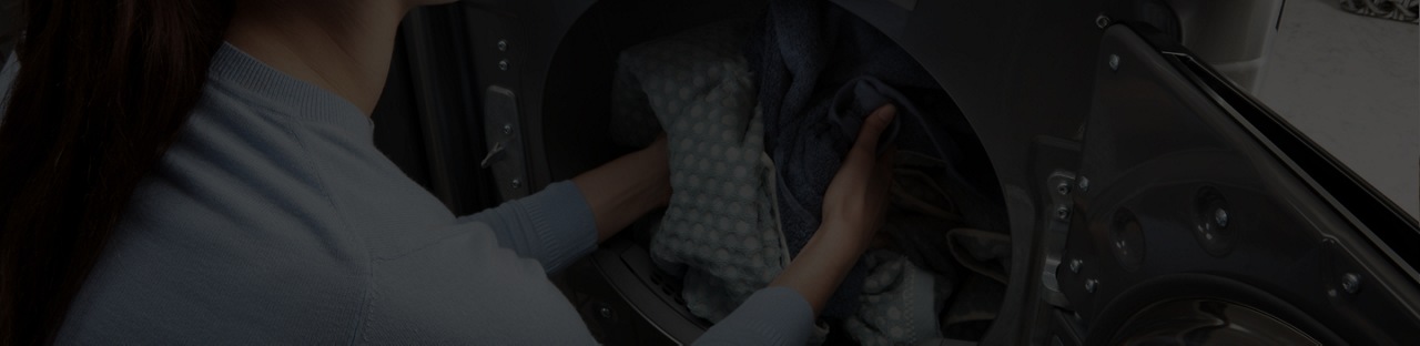 Unloading laundry from a Maytag® dryer.