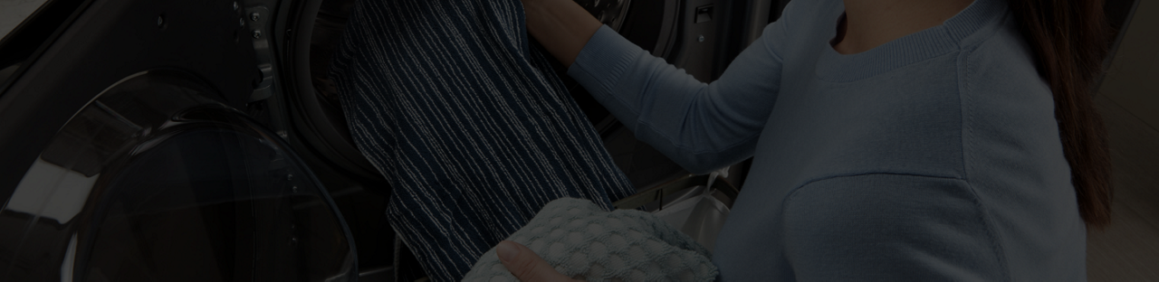 Loading clothes in the washer. 