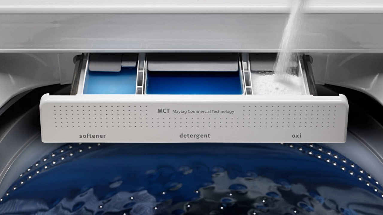 Filling a Maytag® washing machine dispenser with detergent. Filling a Maytag® washing machine dispenser with detergent.