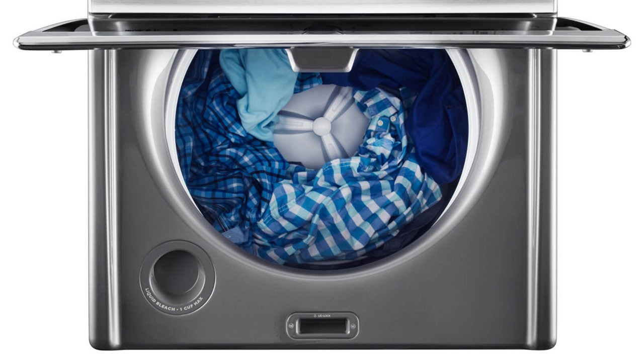 Maytag® top-load washer properly loaded with clothes. Maytag® top-load washer properly loaded with clothes.