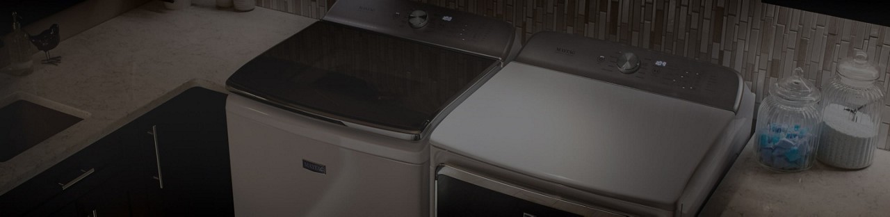 A sleek laundry room featuring a Maytag® washer and dryer pair.