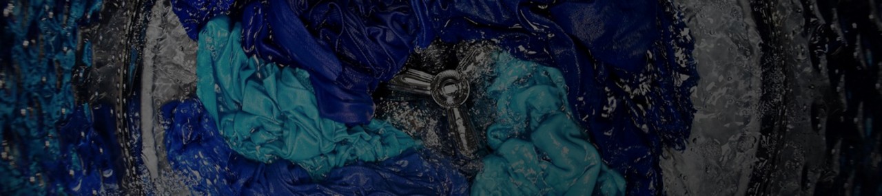 Blue clothes being washed in a Maytag® top-load washer.