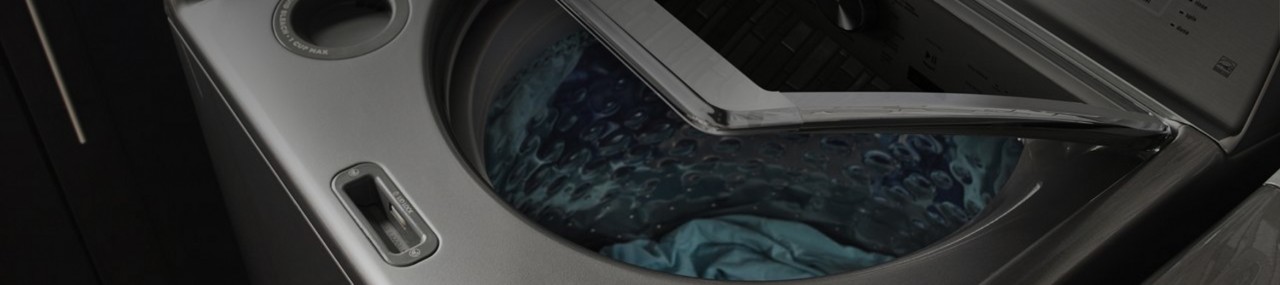 A Maytag® top-load washer with its door open.