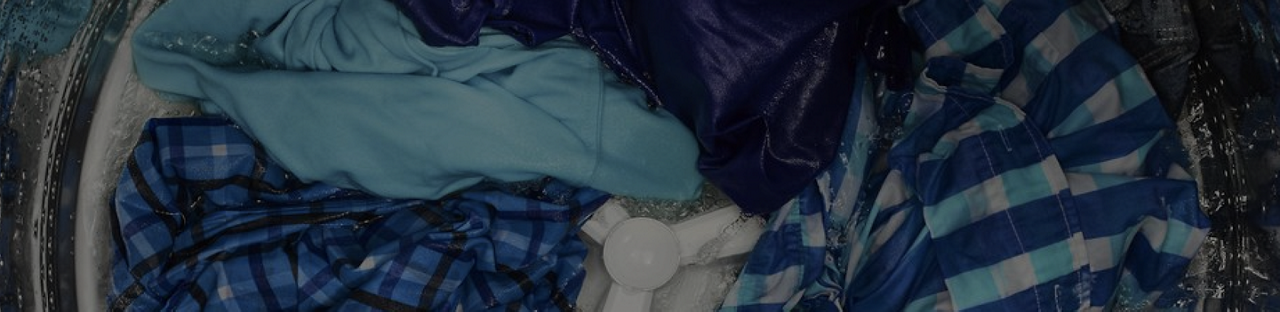 Internal view of a Maytag® washing machine that's washing clothes.