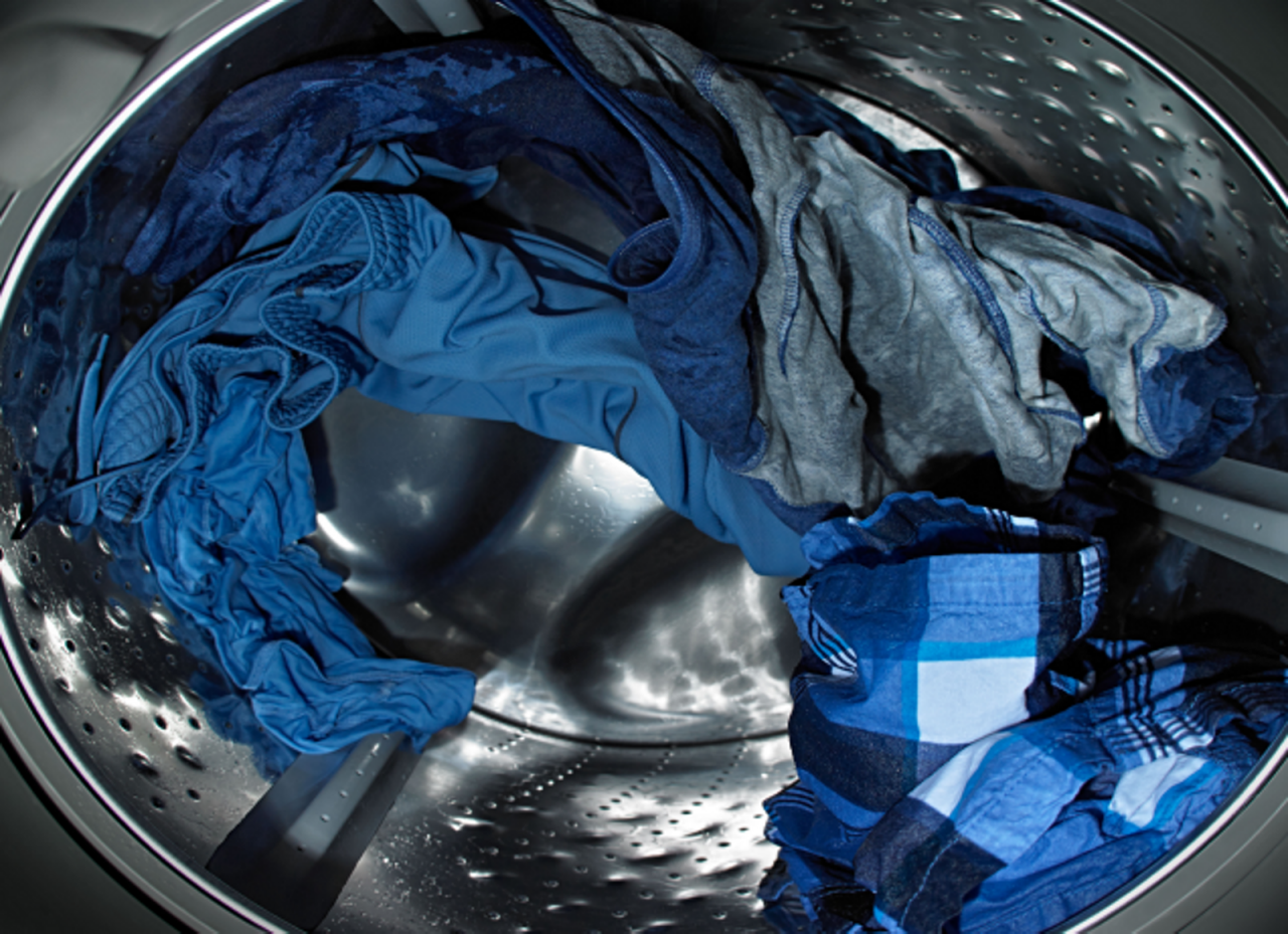 Clothes tumbling in a Maytag front load washer.