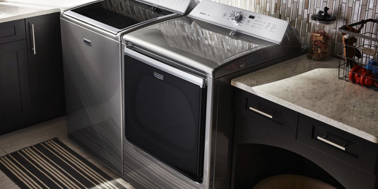 A Maytag stainless steel washer and dryer set in a laundry room. A Maytag stainless steel washer and dryer set in a laundry room.