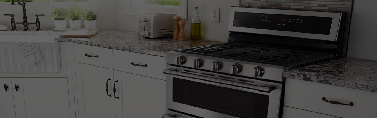 A slide-in Maytag range between two counters.