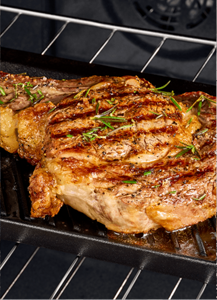 A steak cooking in a Maytag® oven