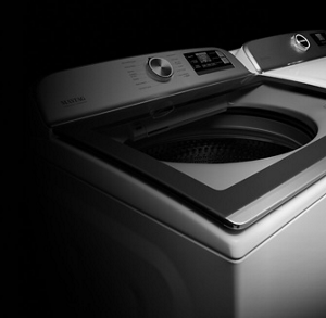 A white Maytag® top load washer and dryer