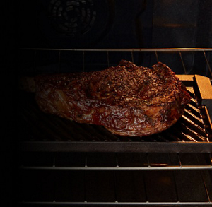 Steak grilling inside a Maytag® oven with Grill Mode