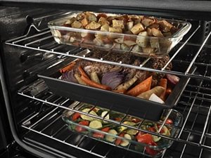 Closeup of food cooking on multiple racks