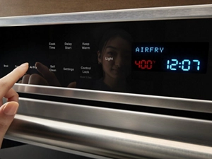 Hand selecting an oven setting
