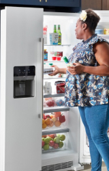 Person grabbing food from a French door refrigerator